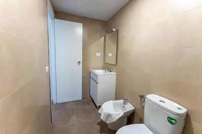 a bathroom with a toilet and a sink at Precioso apartamento en altura in Altura