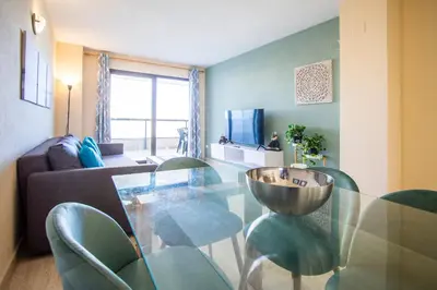 a living room with a glass table and chairs at ESPACIO 5 - Primera Línea de Playa in Cullera