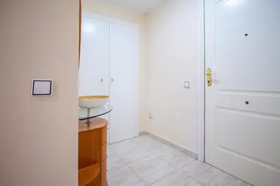 a bathroom with a sink and a white door at ESPACIO 5 - Primera Línea de Playa in Cullera