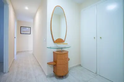 a dressing room with a mirror and a wooden dresser at ESPACIO 5 - Primera Línea de Playa in Cullera