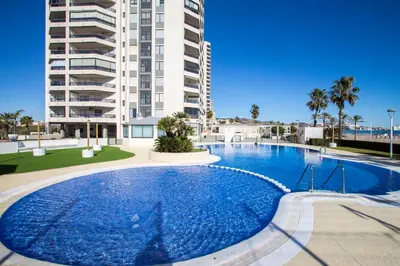 a large swimming pool in front of a building at ESPACIO 5 - Primera Línea de Playa in Cullera
