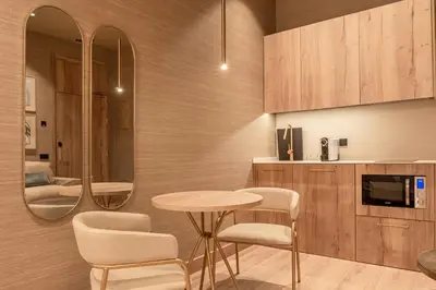 a kitchen with a table and chairs and a mirror at The Valentia Corretgería in Valencia