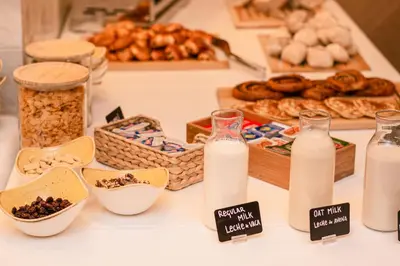 a table topped with bottles of milk and other food at The Valentia Corretgería in Valencia