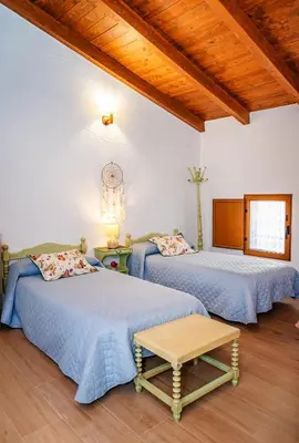a bedroom with two beds and a wooden ceiling at Casa rural la balsa in Anna