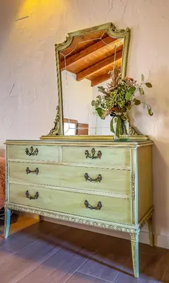 a dresser with a mirror on top of it at Casa rural la balsa in Anna