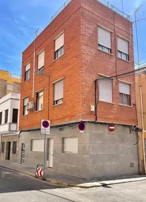 a large brick building on the side of a street at UIM Mediterraneo Virgen del Carmen 1 Wifi in Puerto de Sagunto