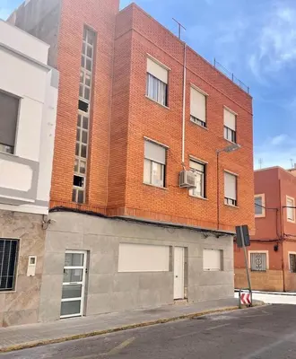 a red brick building on the side of a street at UIM Mediterraneo Virgen del Carmen 1 Wifi in Puerto de Sagunto