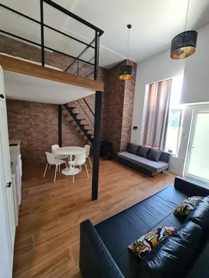 a living room with a loft bed and a table at Hlius Brand New Apartments in Valencia