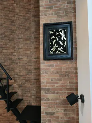 a brick wall with a painting on it at Hlius Brand New Apartments in Valencia