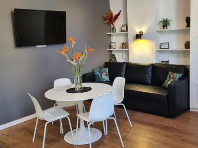 a living room with a table and a couch at Hlius Brand New Apartments in Valencia