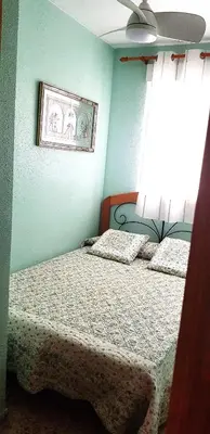 a bedroom with two beds and a window at Spacious apartment in Tavernes de la Valldigna with sea view in El Brosquil