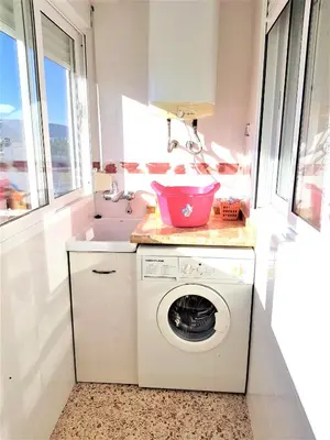 a laundry room with a washing machine and a sink at Spacious apartment in Tavernes de la Valldigna with sea view in El Brosquil