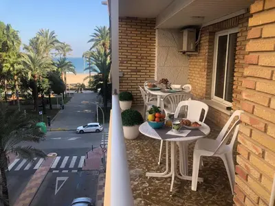 a balcony with two tables and chairs on a house at A 50 m de la plage in Cullera