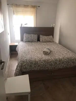 a bed with a pillow on it in a bedroom at A 50 m de la plage in Cullera