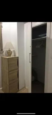 a room with a closet with a lamp and a dresser at A 50 m de la plage in Cullera