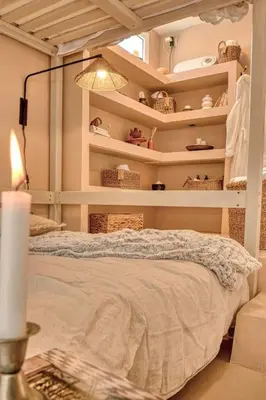 a bedroom with a bed with shelves and a lamp at Suite con Jacuzzi en la montaña. in Llombay