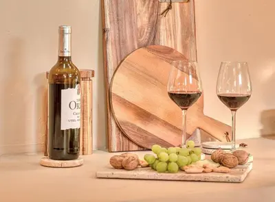 a bottle of wine next to two glasses of wine at Suite con Jacuzzi en la montaña. in Llombay