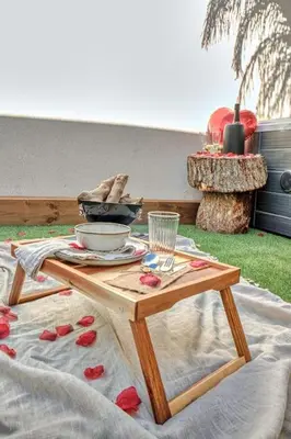 a wooden table with a tray of food on it at Suite con Jacuzzi en la montaña. in Llombay