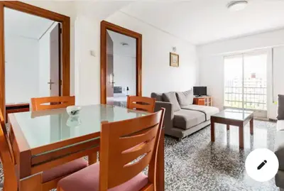 a living room with a glass table and a couch at private room in shared apartment Valencia WorkStay in Valencia