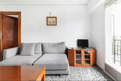 a living room with a couch and a table at private room in shared apartment Valencia WorkStay in Valencia