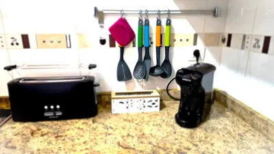 a kitchen counter with a toaster and utensils at BEACH VALENCIA LUXURY B40-7 Apartament on Beach in Valencia