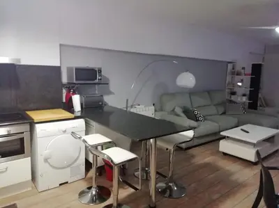 a kitchen and living room with a couch and a table at Apartamento playa in Playa Pobla de Farnals