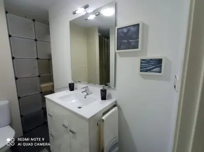 a bathroom with a sink and a mirror at Apartamento playa in Playa Pobla de Farnals
