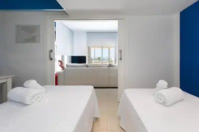 two beds in a room with a living room at luxury sea view apartment with 2 rooms in Valencia