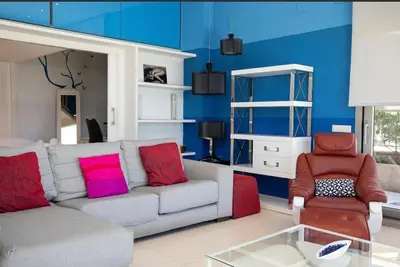 a living room with a couch and a chair at luxury sea view apartment with 2 rooms in Valencia