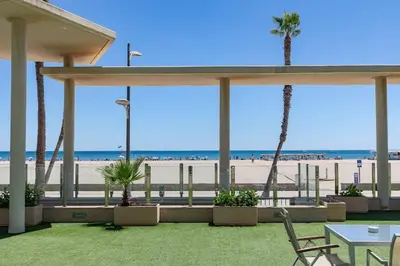 a view of the beach from a pavilion at the beach at luxury sea view apartment with 2 rooms in Valencia