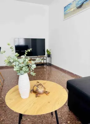 a turtle sitting on a table with a vase on it at Citadella Apartment in Puerto de Sagunto