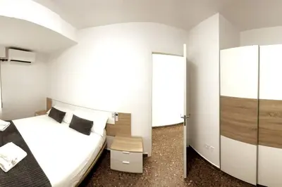 a hotel room with a bed and a mirror at Citadella Apartment in Puerto de Sagunto