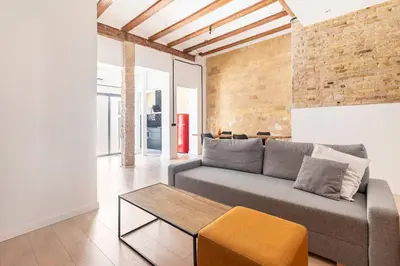 a living room with a couch and a table at PR27 in Valencia
