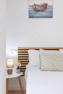 a bedroom with a bed and a table with a lamp at Aparthotel Mediterráneo by NeoHotels-Centro 8 min by Metro in Valencia