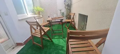 a room with chairs and a table and a green floor at Aparthotel Mediterráneo by NeoHotels-Centro 8 min by Metro in Valencia