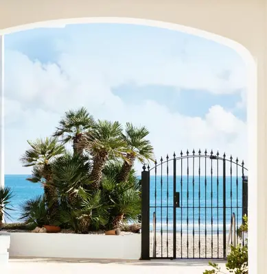 an open gate with a view of the ocean at Almar Collection Cullera AR in Cullera