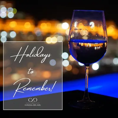 a glass of wine sitting on top of a table at Colina del Sol Penthouse Horizonte in Cullera