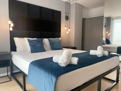 a bedroom with a large bed with towels on it at Colina del Sol Penthouse Horizonte in Cullera