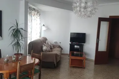a living room with a couch and a table at Apartamento 1ª línea de Playa in Puebla de Farnals