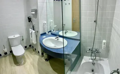 a bathroom with two sinks and a toilet at Holiday Inn Express Ciudad de las Ciencias by IHG in Valencia
