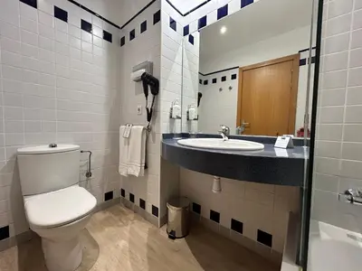 a bathroom with a toilet and a sink at Holiday Inn Express Ciudad de las Ciencias by IHG in Valencia