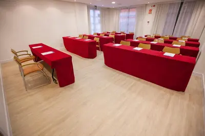 a conference room with red tables and chairs at Holiday Inn Express Ciudad de las Ciencias by IHG in Valencia