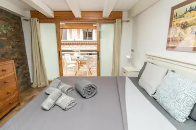 a bedroom with a bed with towels on it at Loft con terraza centro Valencia in Valencia