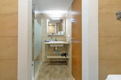 a bathroom with a sink and a mirror at Loft con terraza centro Valencia in Valencia