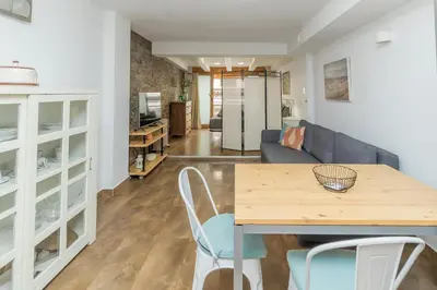 a kitchen and living room with a table and chairs at Loft con terraza centro Valencia in Valencia