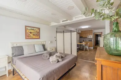 a bedroom with a bed with towels on it at Loft con terraza centro Valencia in Valencia