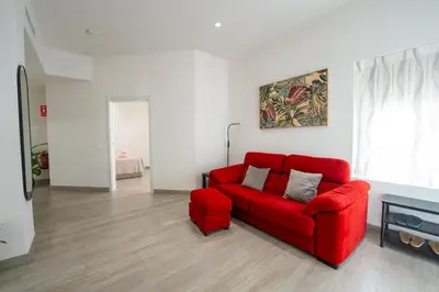 a red couch sitting in a living room at Mimi's Apartment in En Corts in Valencia
