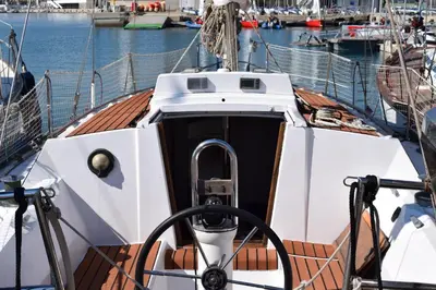 a boat is docked at a dock in the water at Velero en Puerto de Valencia - E&M Boats in Valencia