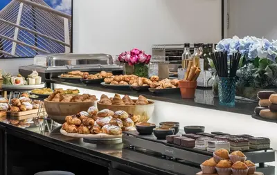 a buffet with many different types of pastries and desserts at Hotel Medium Valencia in Valencia