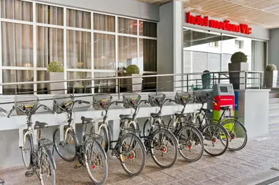 a row of bikes parked in front of a building at Hotel Medium Valencia in Valencia